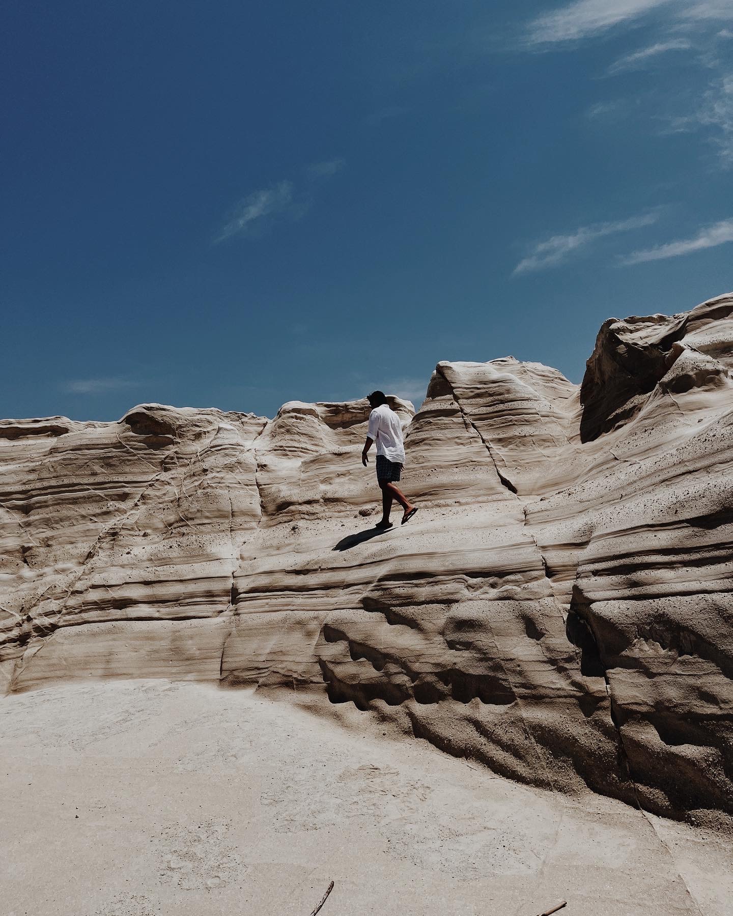 Walking the white volcanic cliffs of Sarakiniko, Milos